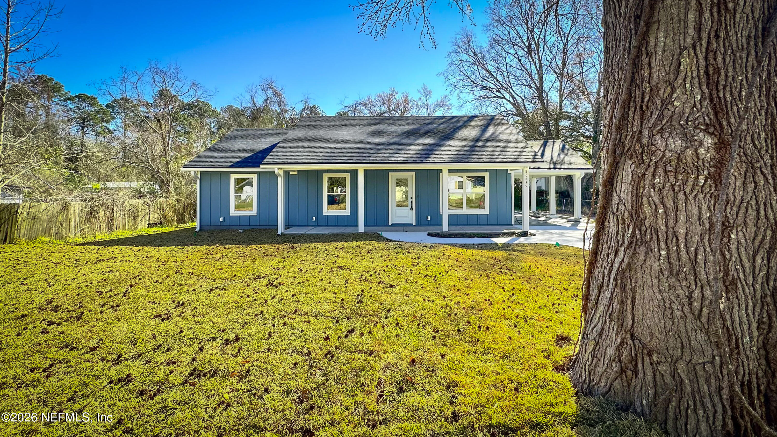 86549 Hester Drive Yulee, FL 32097 - Photo 1 of 18 front view of a house with a yard