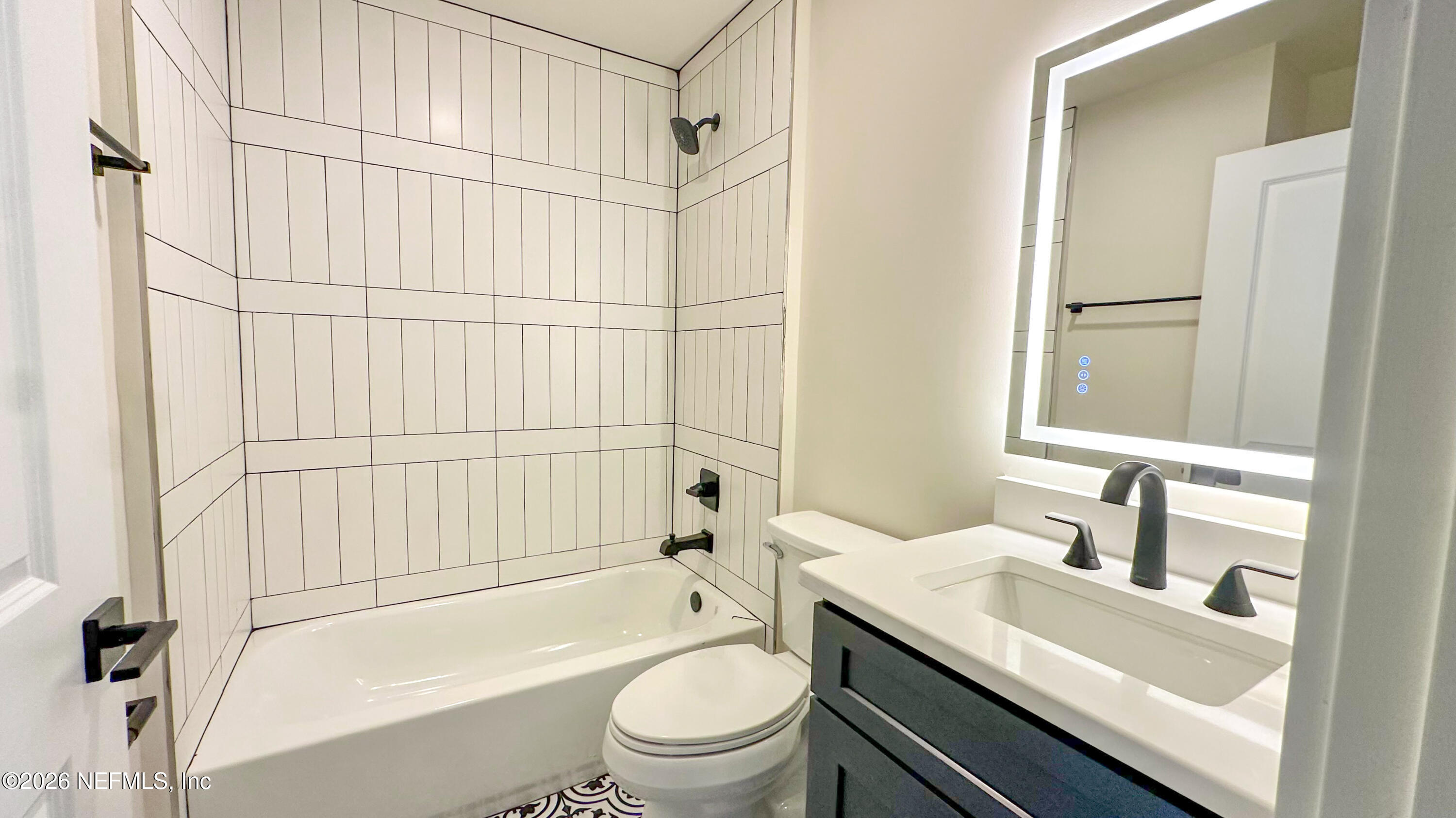 86549 Hester Drive Yulee, FL 32097 - Photo 12 of 18 a bathroom with a granite countertop sink toilet and shower