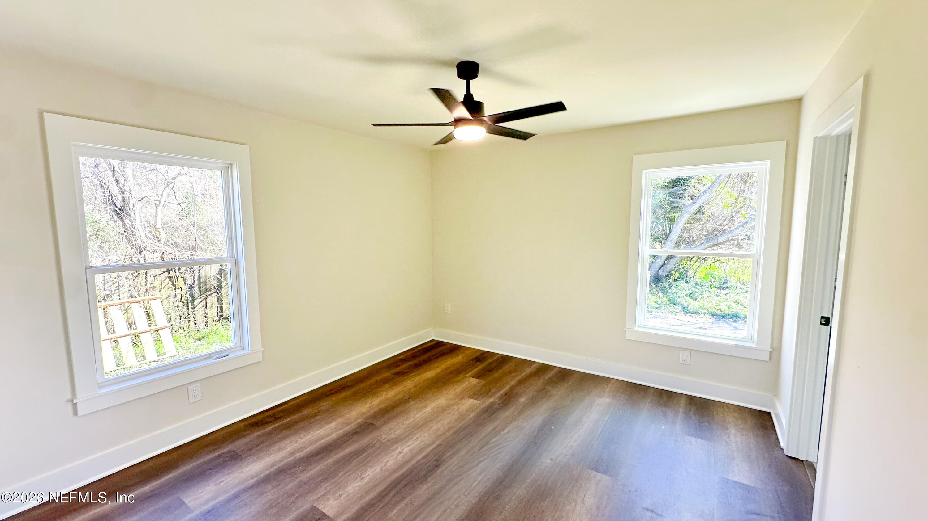 86549 Hester Drive Yulee, FL 32097 - Photo 7 of 18 a view of empty room with wooden floor and fan