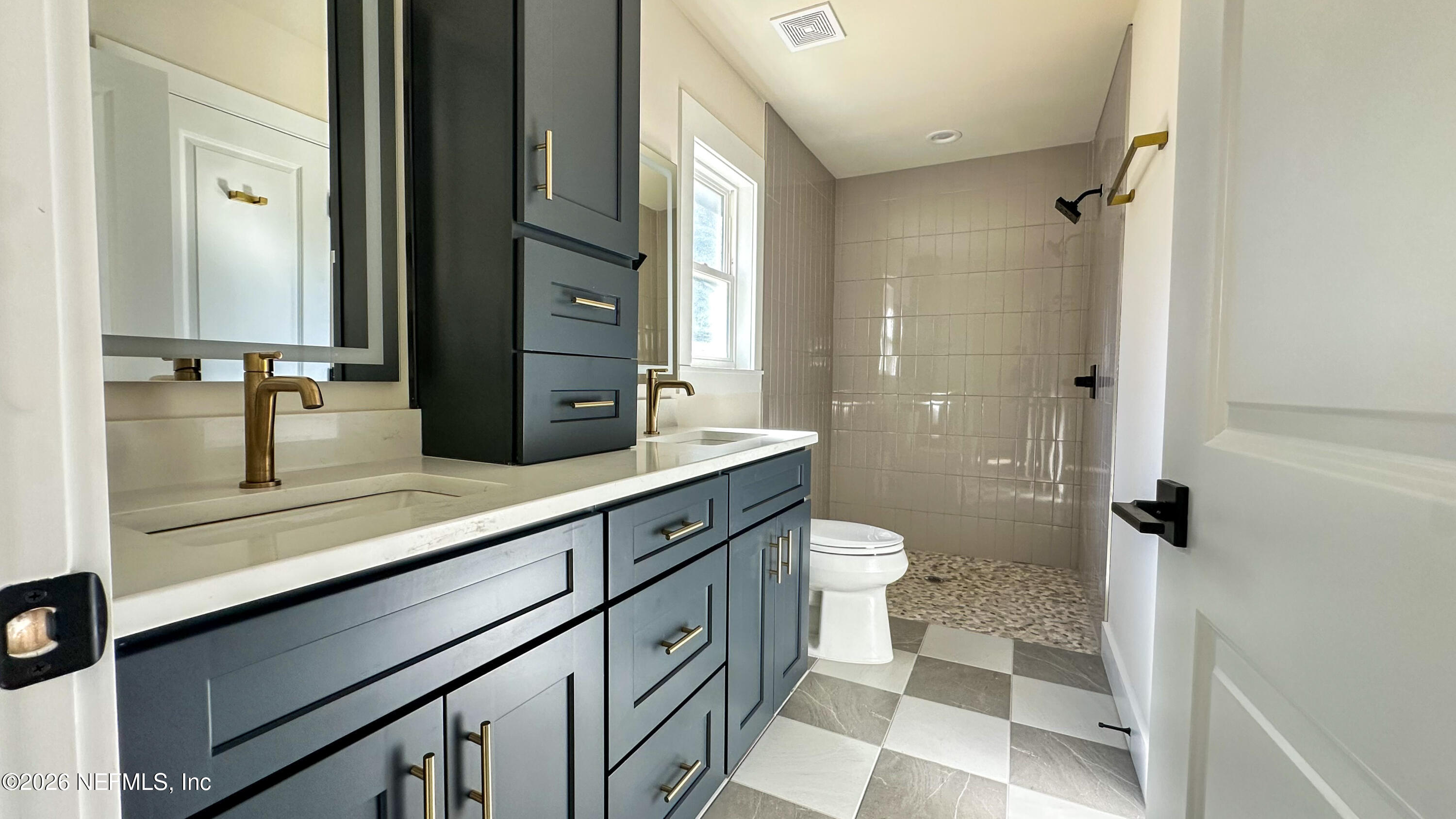 86549 Hester Drive Yulee, FL 32097 - Photo 8 of 18 a bathroom with a double vanity sink toilet and shower