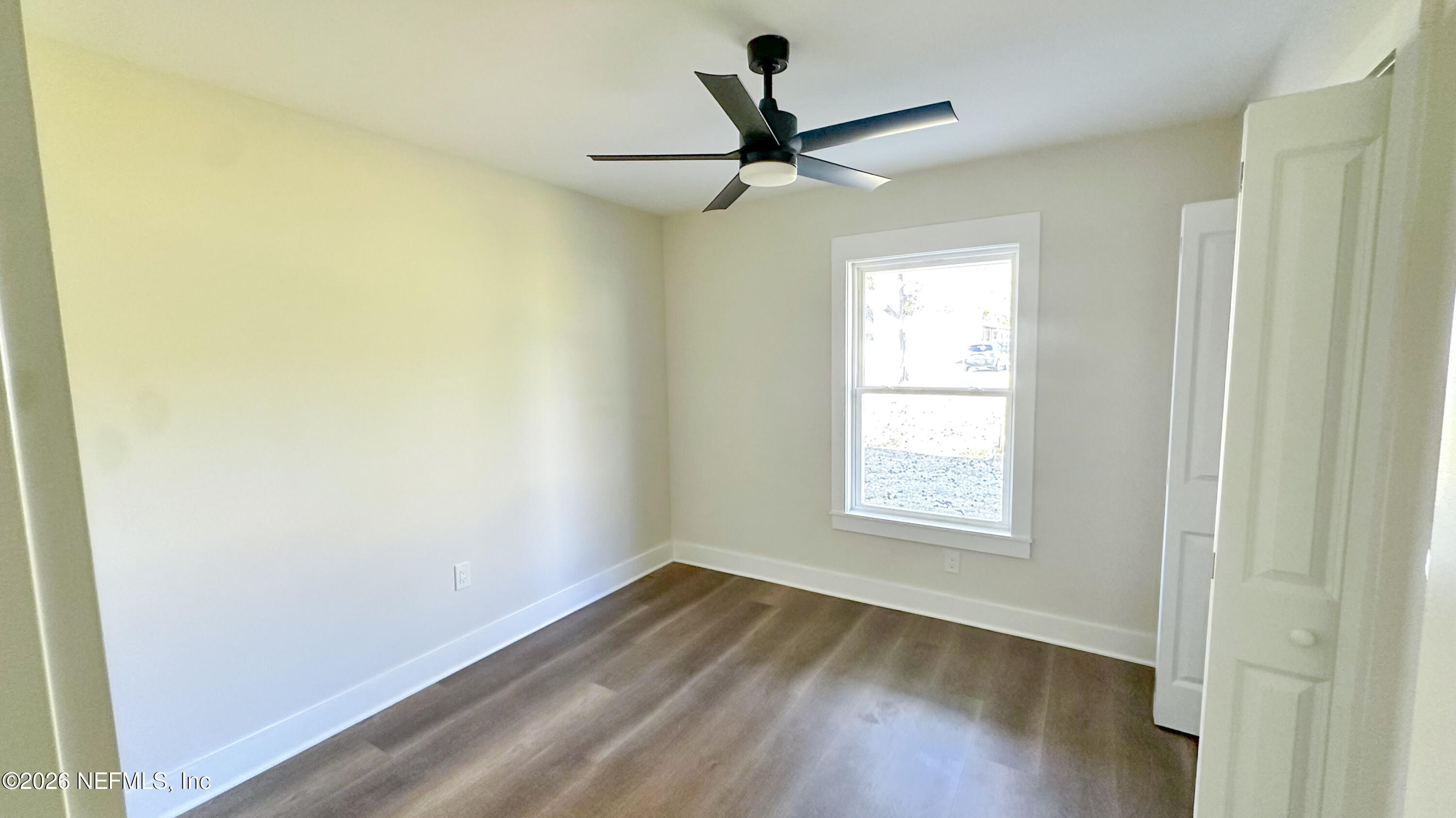86549 Hester Drive Yulee, FL 32097 - Photo 10 of 18 a view of empty room with wooden floor and fan