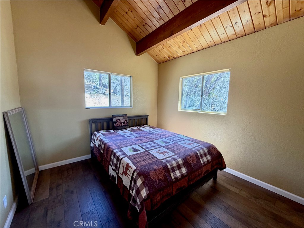 2190 Tank Running Springs Running Springs, CA 92382 - Photo 16 of 33 a bedroom with a bed and wooden floor