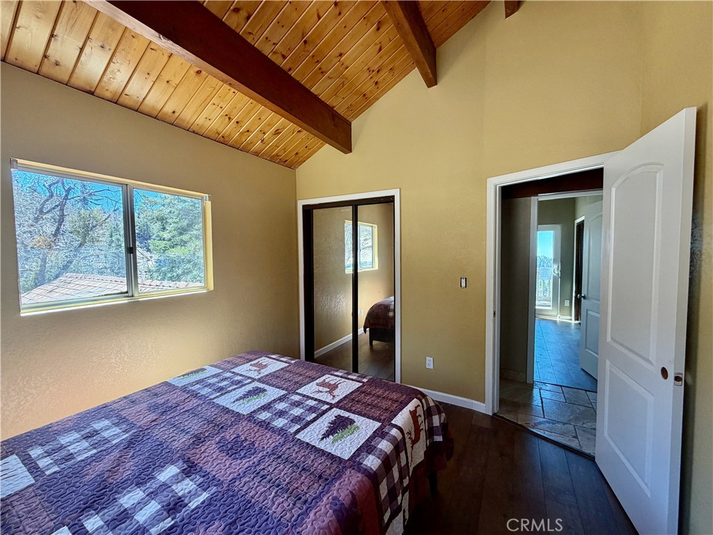 2190 Tank Running Springs Running Springs, CA 92382 - Photo 17 of 33 a bedroom with bed and wooden floor
