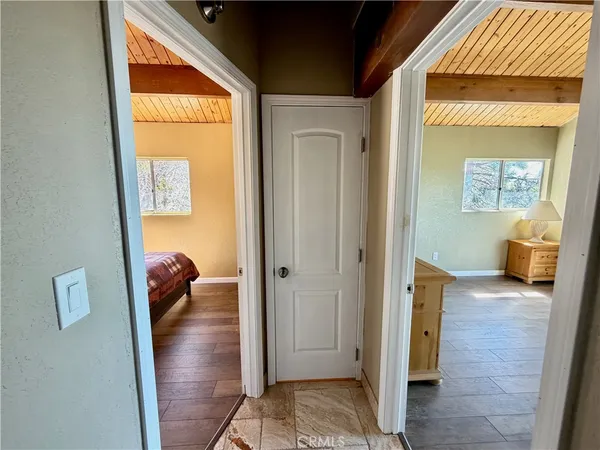 a view of a hallway to a livingroom with furniture