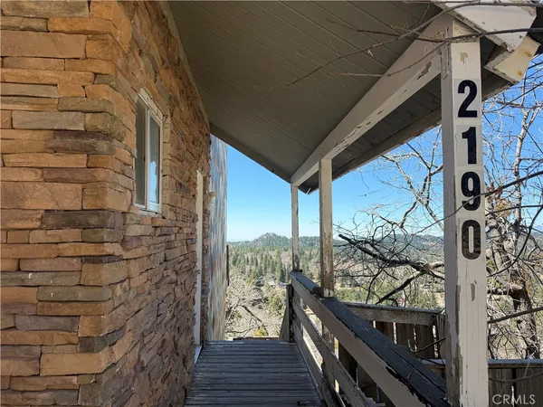 a view of a balcony with wooden floor and stairs