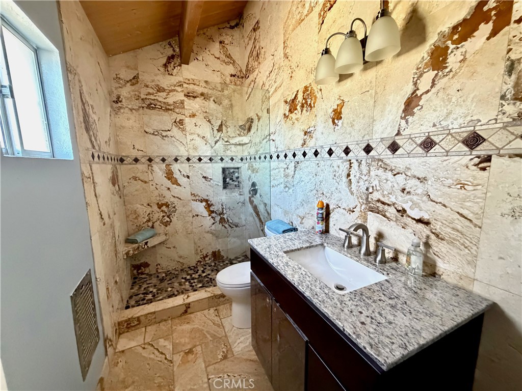 2190 Tank Running Springs Running Springs, CA 92382 - Photo 22 of 33 a bathroom with a granite countertop sink and a mirror