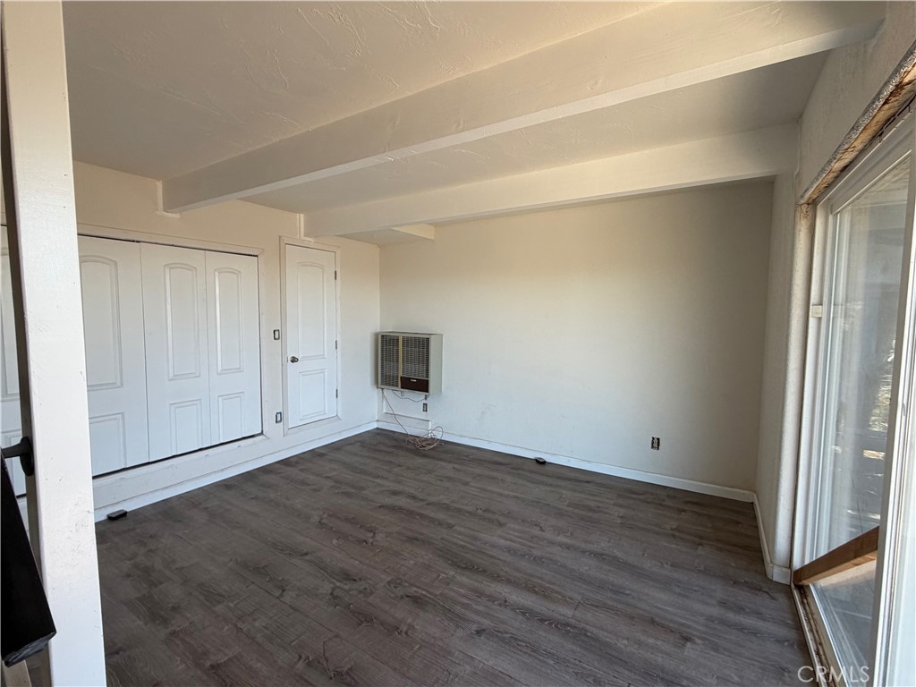 2190 Tank Running Springs Running Springs, CA 92382 - Photo 27 of 33 an empty room with wooden floor and windows