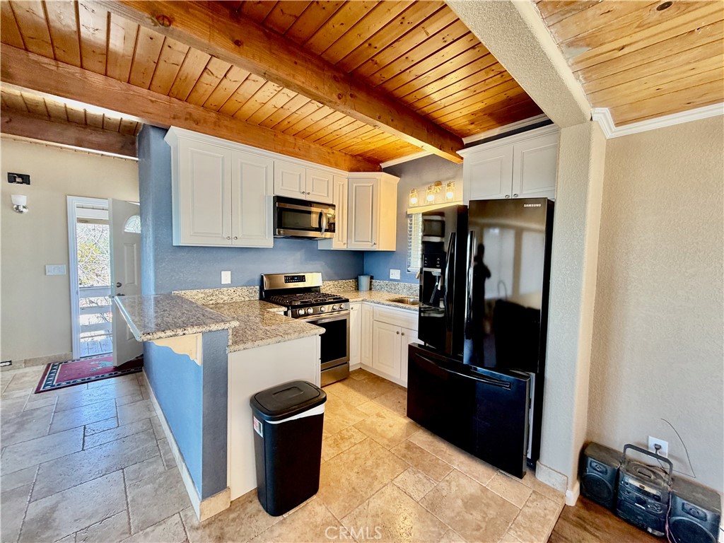 2190 Tank Running Springs Running Springs, CA 92382 - Photo 7 of 33 a kitchen with stainless steel appliances granite countertop a refrigerator stove and sink