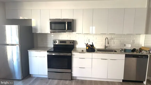 a kitchen with a sink stove and microwave