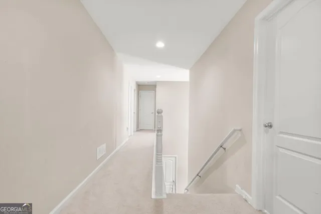 a spacious bedroom with a bed a couch and a flat tv screen