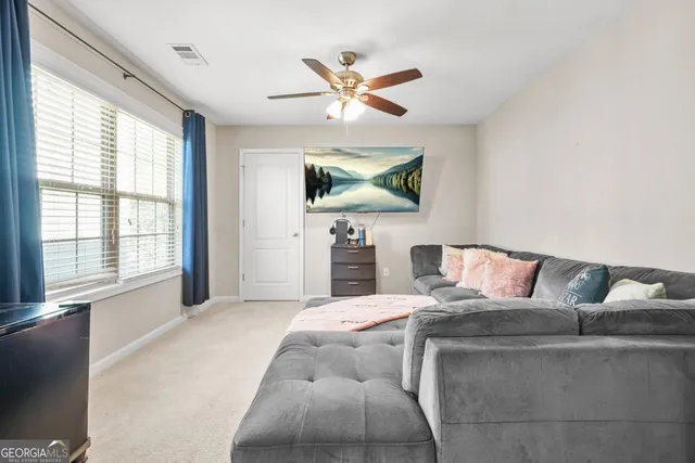 a living room with a couch and a chandelier