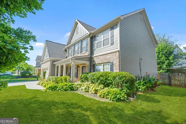 a front view of a house with a garden