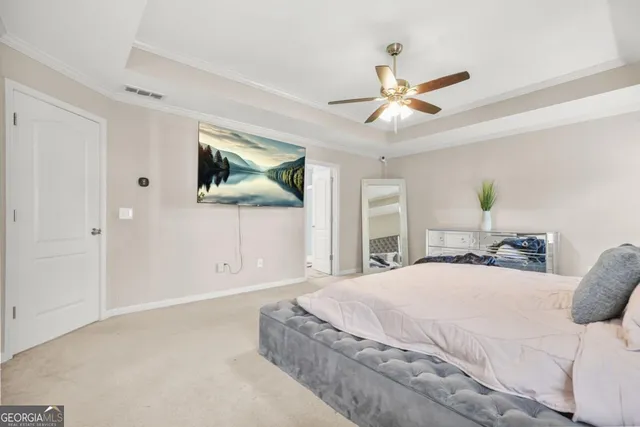 a spacious bedroom with a large bed and a chandelier