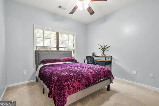 a bed sitting in a bedroom next to a window