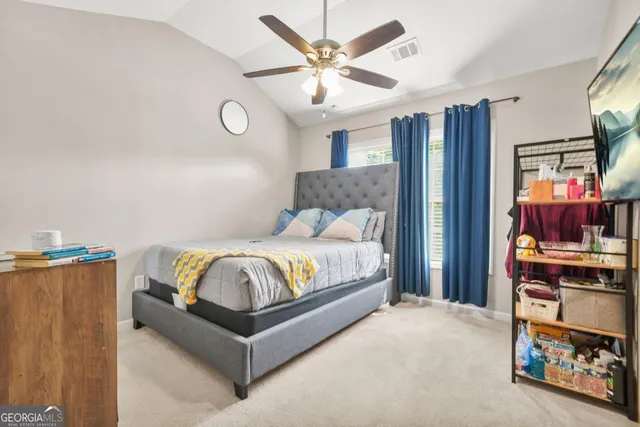 a bedroom with bed and a chandelier