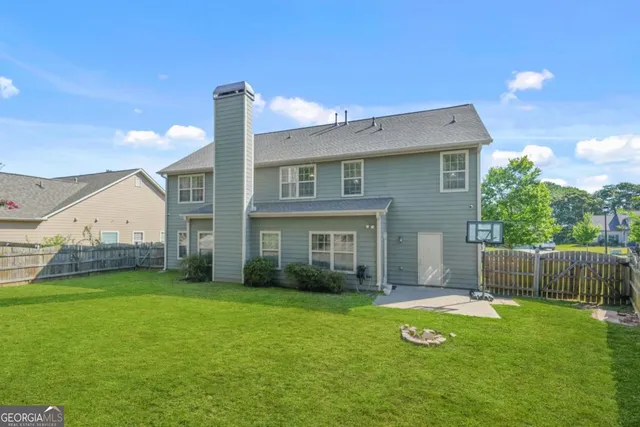 a view of a house with a yard and table