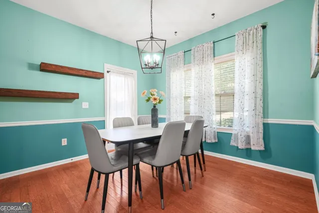 a view of a dining room with furniture window and wooden floor