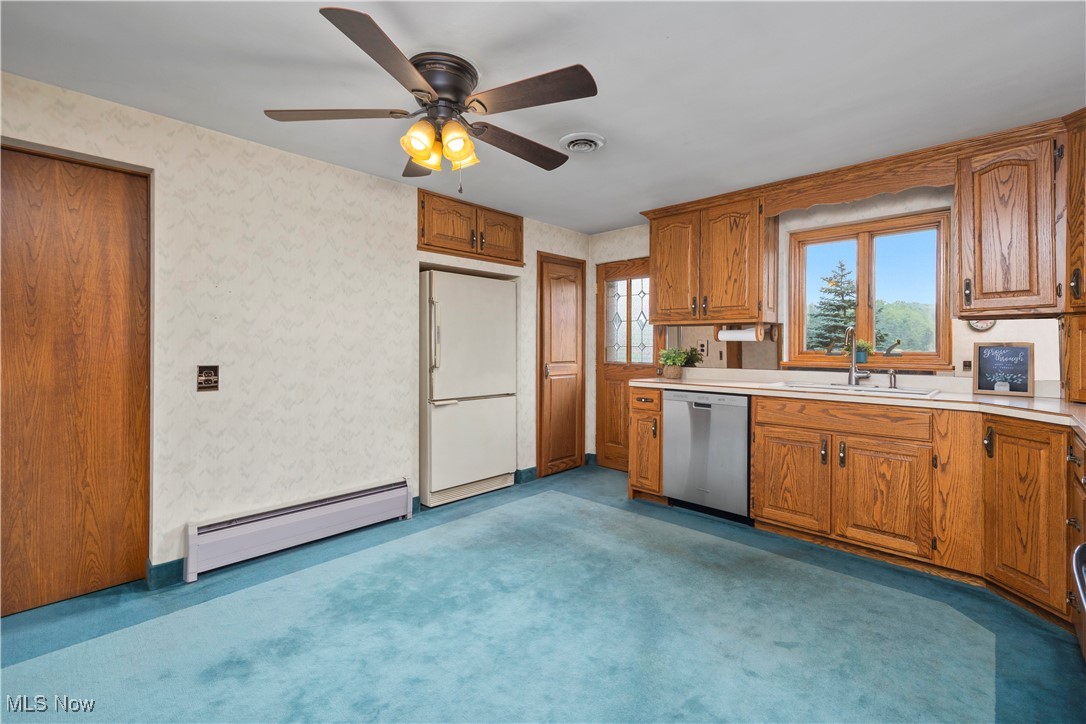 144 Substation Road Brunswick, OH 44212 - Photo 11 of 43 Kitchen with dishwasher, a baseboard radiator, white refrigerator, wallpapered walls, and light countertops
