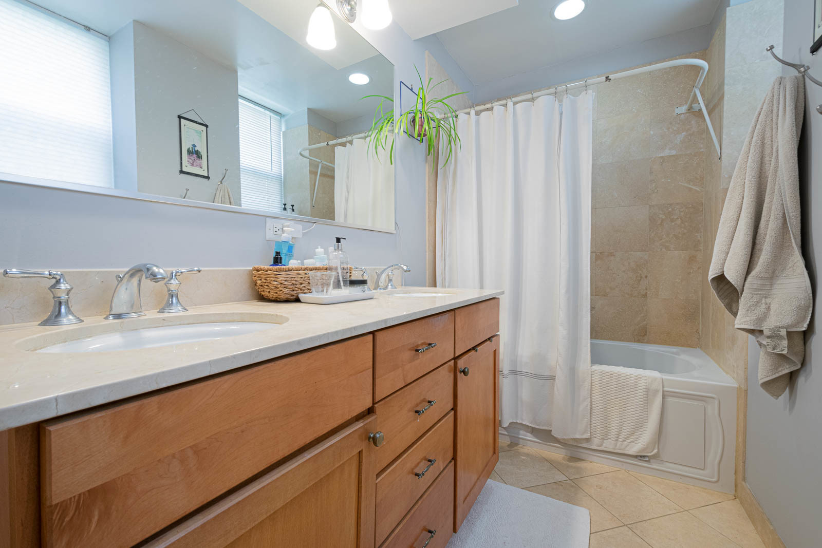 5874 North Ridge Avenue, Unit G Chicago, IL 60660 - Photo 11 of 14 a bathroom with a double vanity sink and a mirror