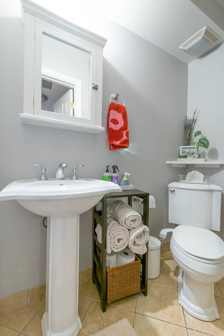 5874 North Ridge Avenue, Unit G Chicago, IL 60660 - Photo 13 of 14 a bathroom with a sink a mirror and a toilet
