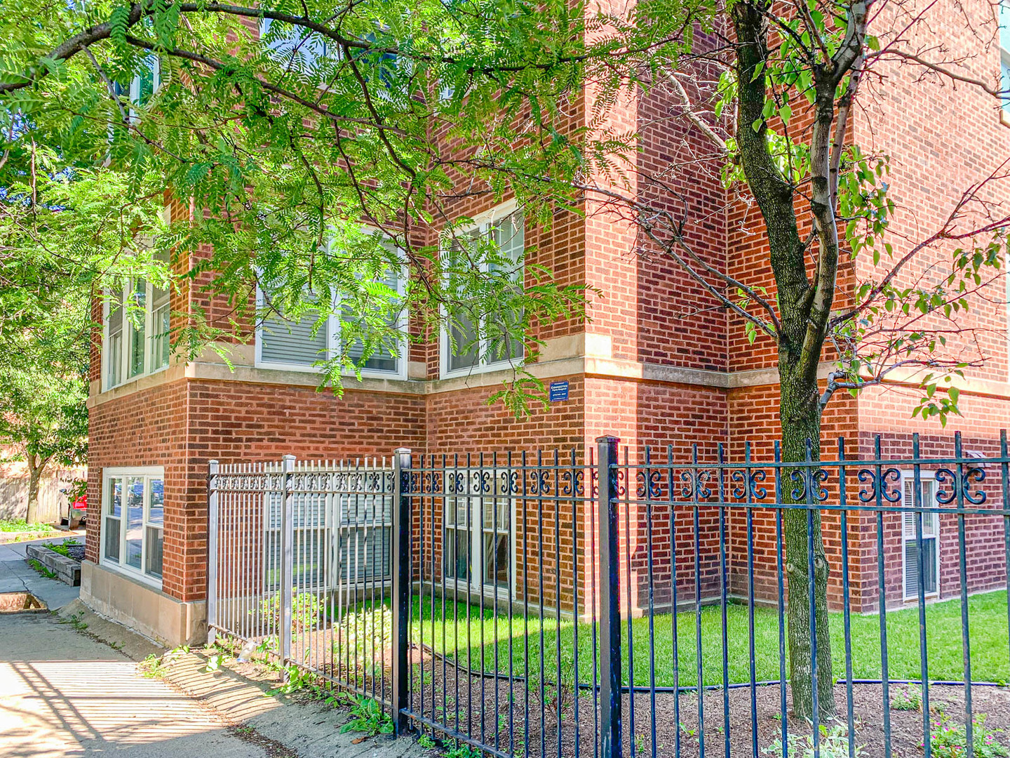 5874 North Ridge Avenue, Unit G Chicago, IL 60660 - Photo 14 of 14 a view of a brick house with a large window and plants