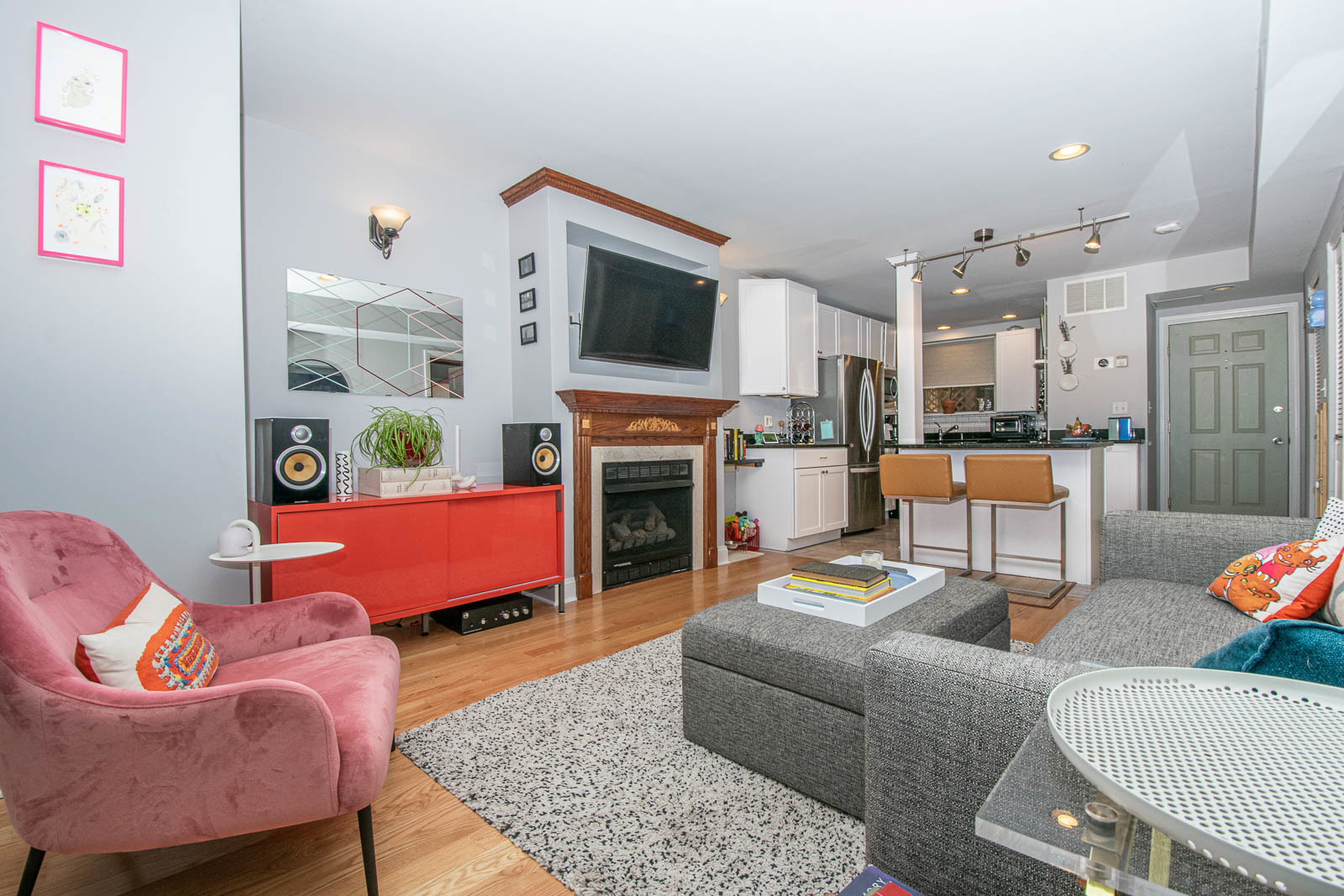 5874 North Ridge Avenue, Unit G Chicago, IL 60660 - Photo 5 of 14 a living room with furniture a flat screen tv and a fireplace