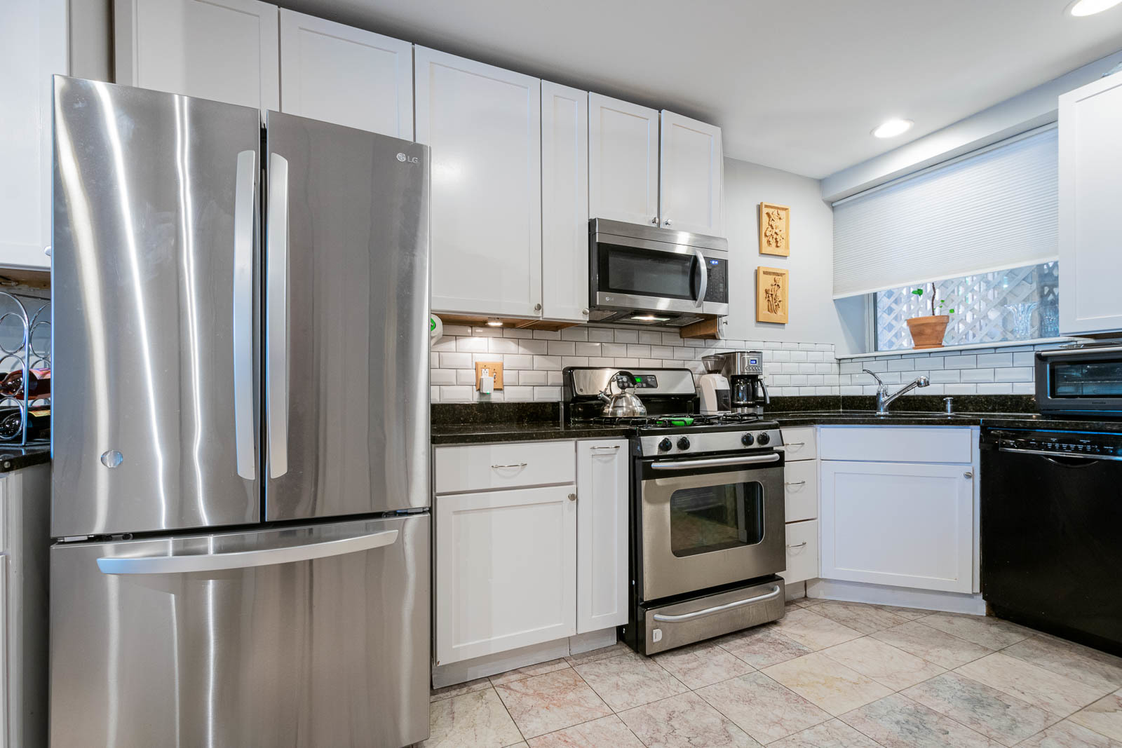 5874 North Ridge Avenue, Unit G Chicago, IL 60660 - Photo 7 of 14 a kitchen with stainless steel appliances a refrigerator sink and microwave