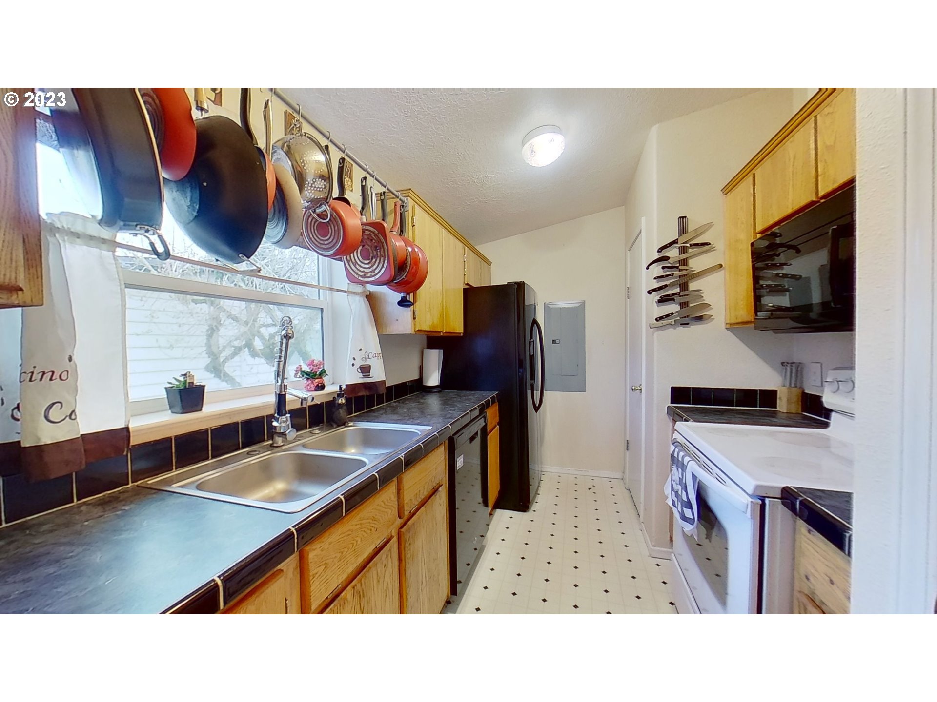 1294 31st Street Springfield, OR 97478 - Photo 9 of 32 a kitchen with stainless steel appliances granite countertop a sink a stove and a refrigerator