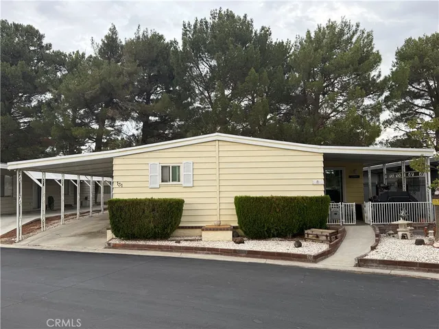a front view of a house with garage and plants