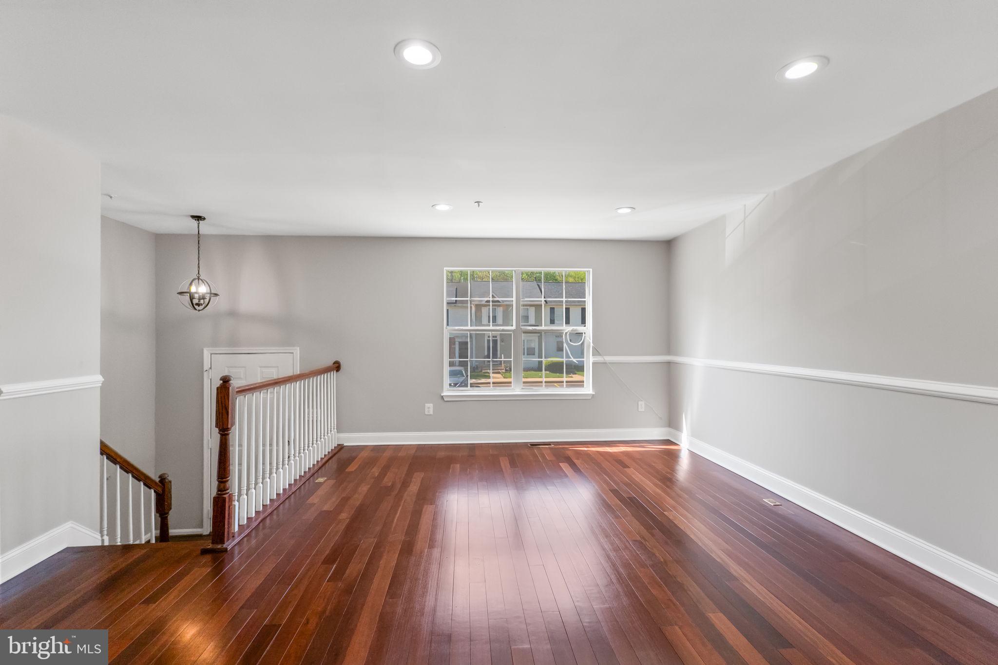3514 Corn Stream Road Randallstown, MD 21133 - Photo 13 of 44 a view of an empty room with wooden floor and a window