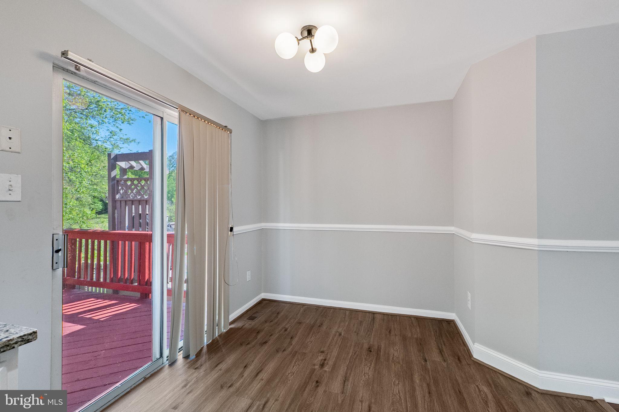 3514 Corn Stream Road Randallstown, MD 21133 - Photo 15 of 44 a view of a hallway with wooden floor and a window