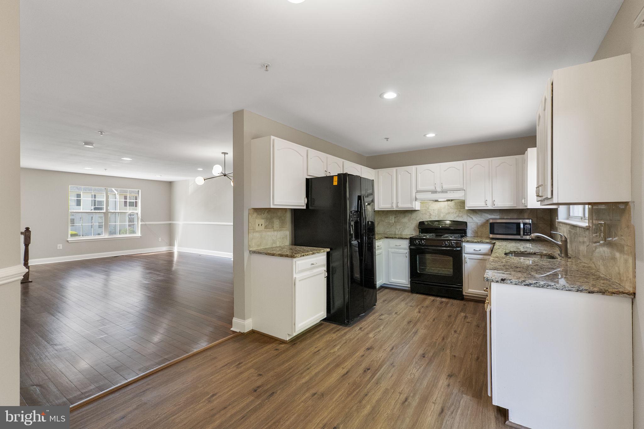 3514 Corn Stream Road Randallstown, MD 21133 - Photo 16 of 44 a kitchen with a refrigerator and a stove top oven