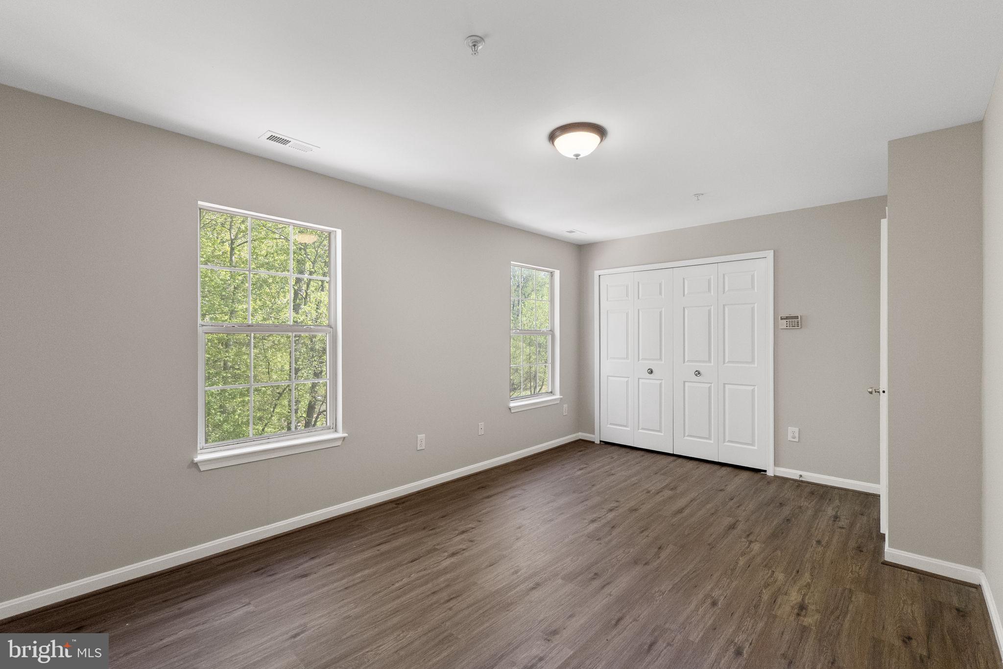 3514 Corn Stream Road Randallstown, MD 21133 - Photo 25 of 44 a view of an empty room with wooden floor and a window