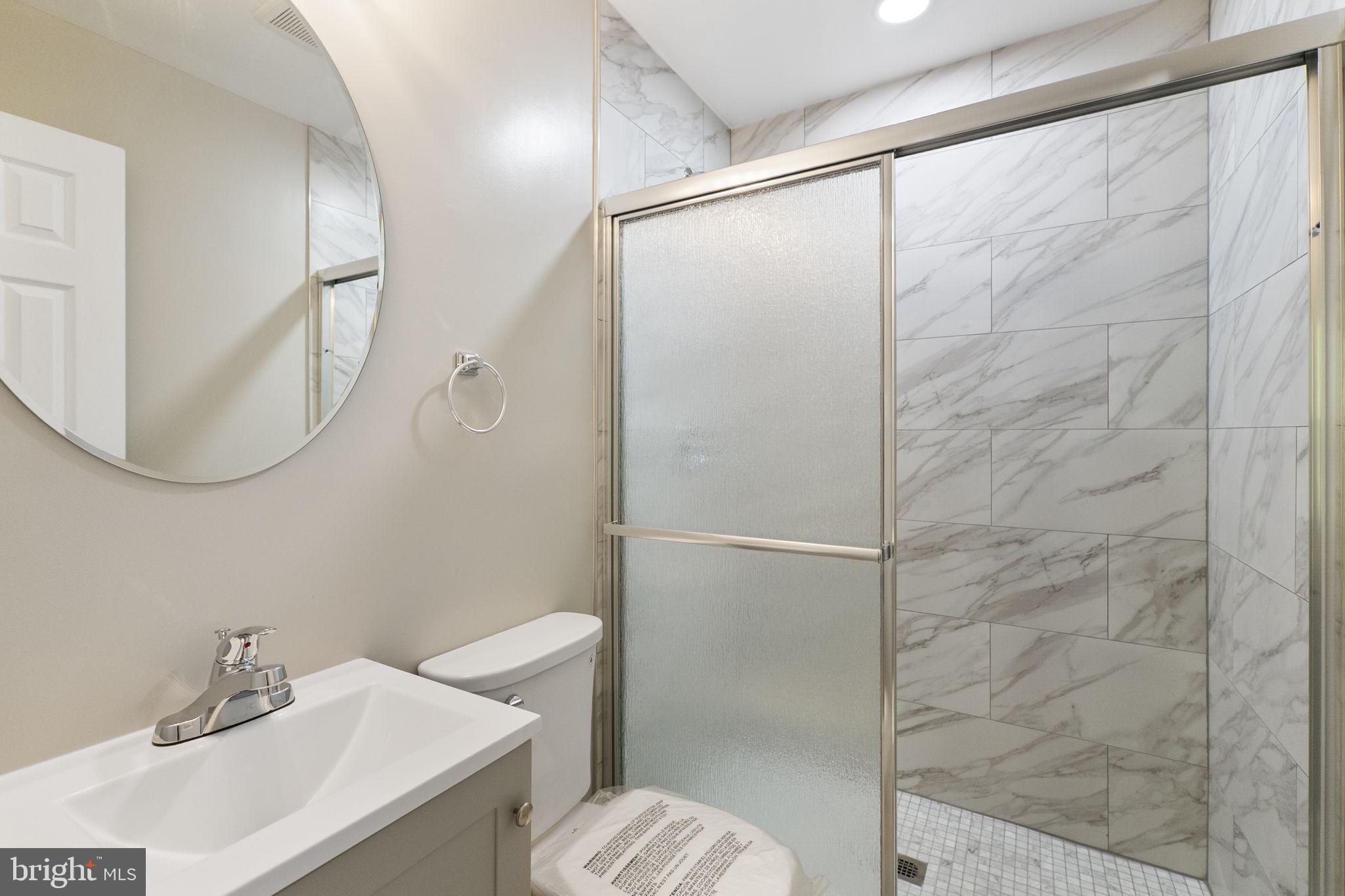 3514 Corn Stream Road Randallstown, MD 21133 - Photo 26 of 44 a bathroom with a sink toilet and shower