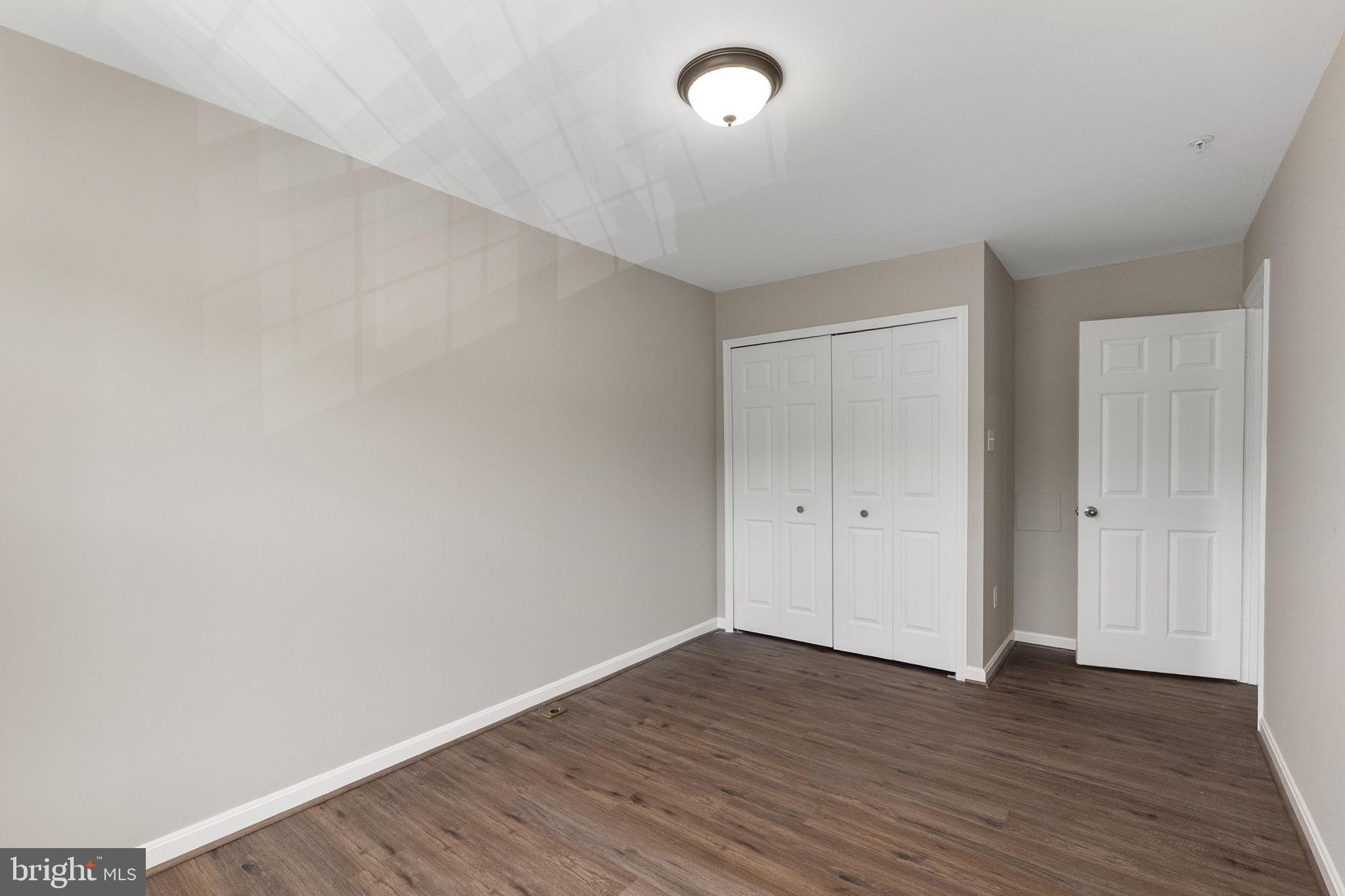 3514 Corn Stream Road Randallstown, MD 21133 - Photo 30 of 44 a view of an empty room with wooden floor