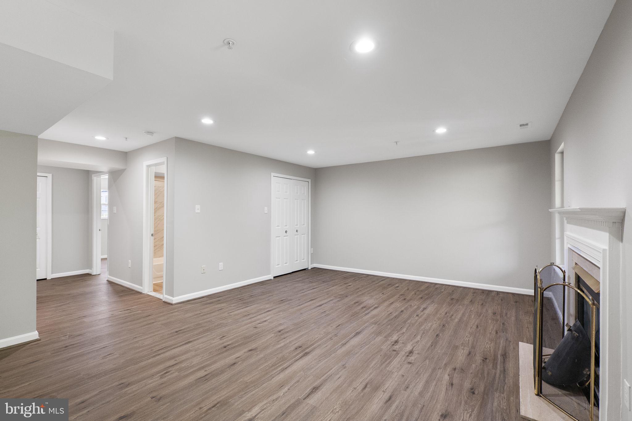 3514 Corn Stream Road Randallstown, MD 21133 - Photo 33 of 44 a view of an empty room with wooden floor and a window