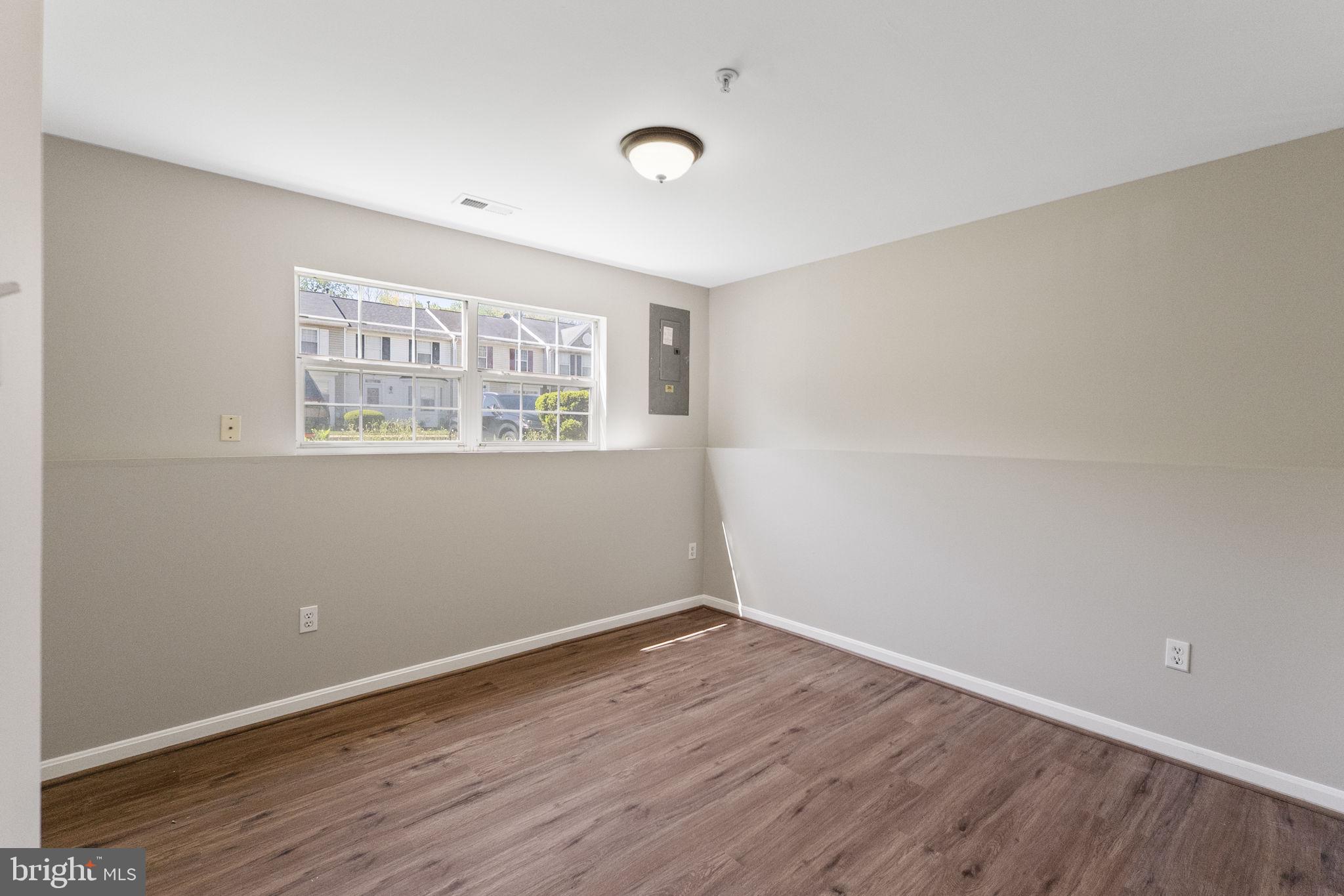3514 Corn Stream Road Randallstown, MD 21133 - Photo 37 of 44 a view of an empty room with wooden floor and a window