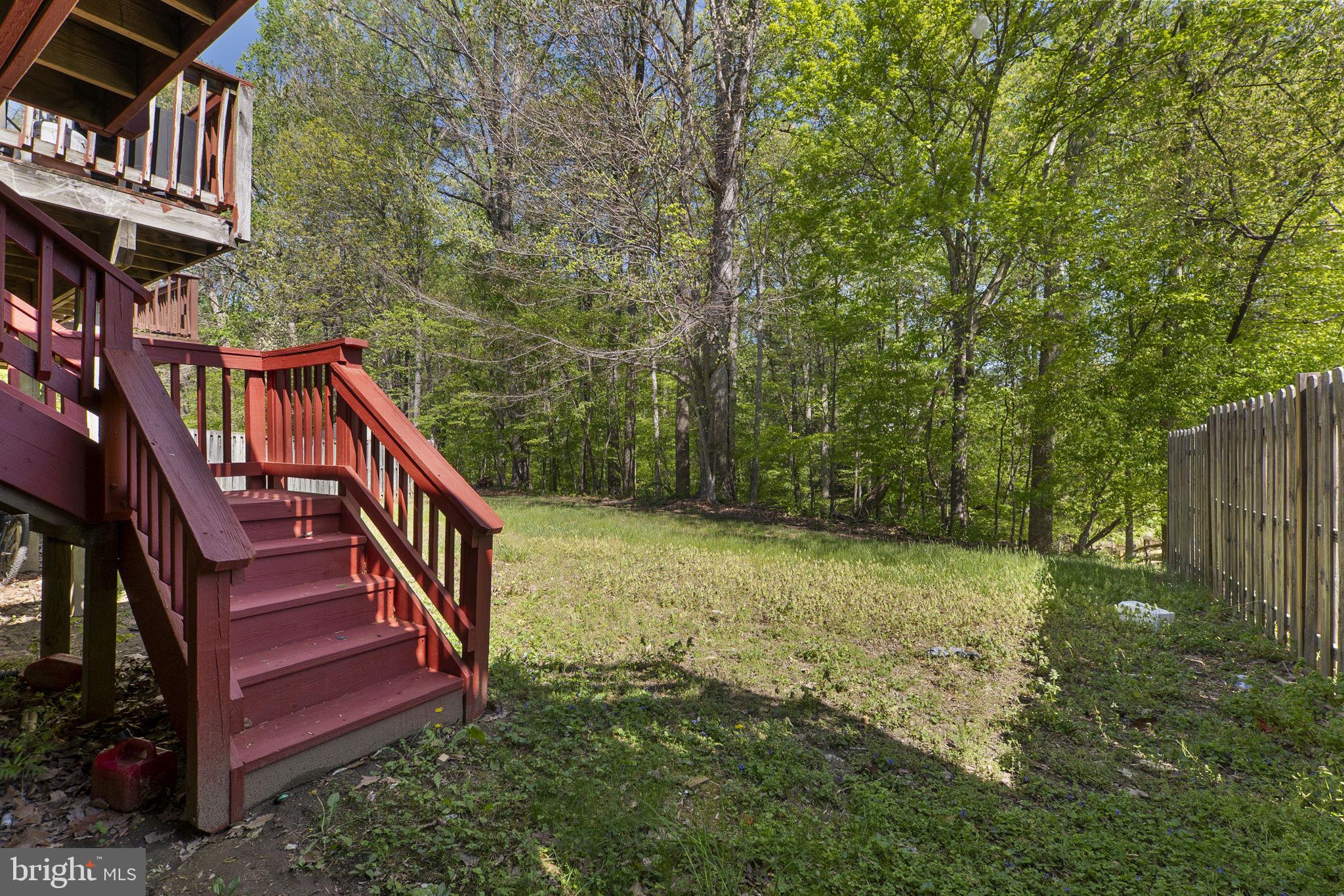 3514 Corn Stream Road Randallstown, MD 21133 - Photo 38 of 44 a view of a yard with large trees and wooden fence