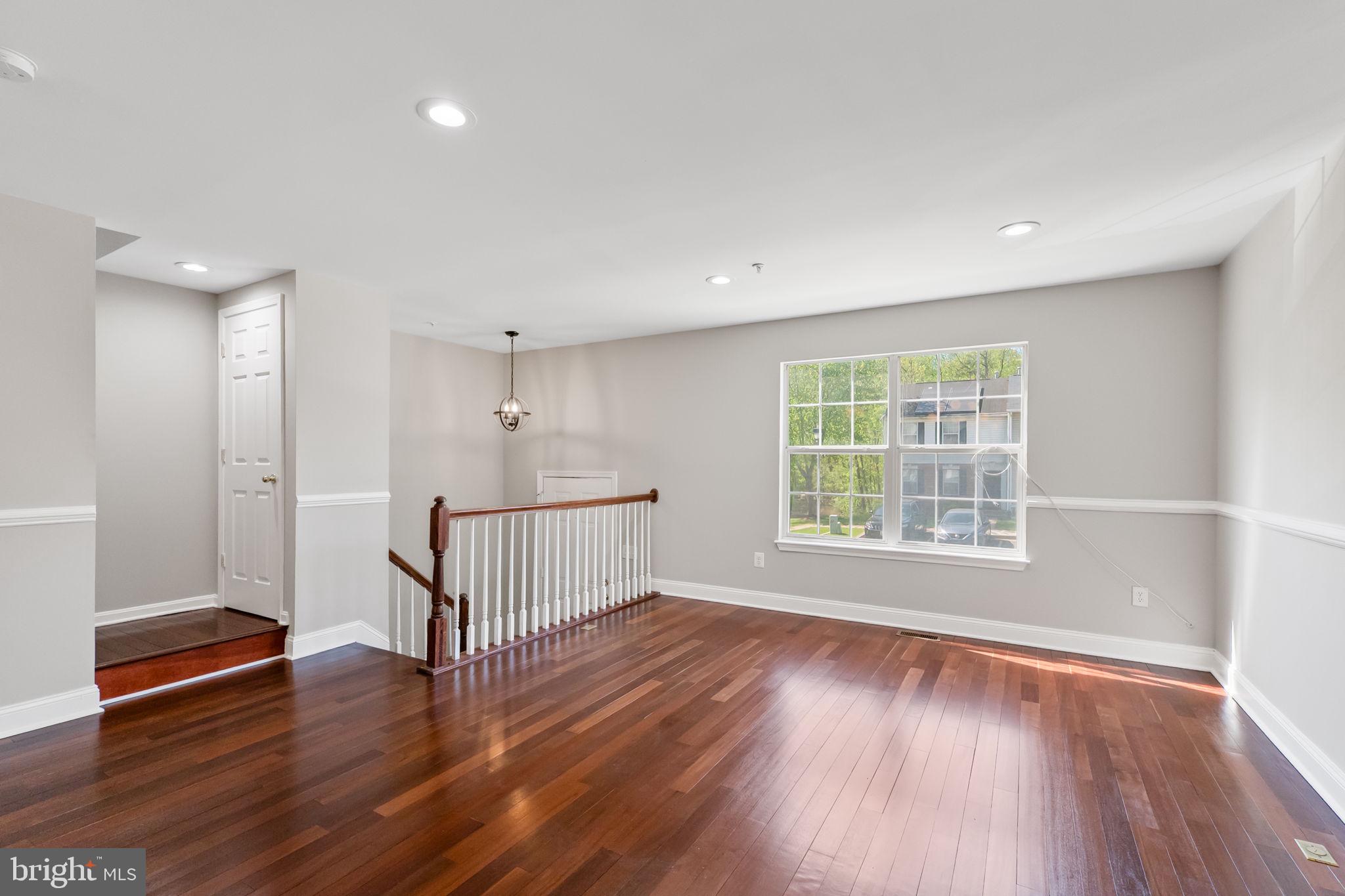 3514 Corn Stream Road Randallstown, MD 21133 - Photo 8 of 44 a view of an empty room with wooden floor and a window