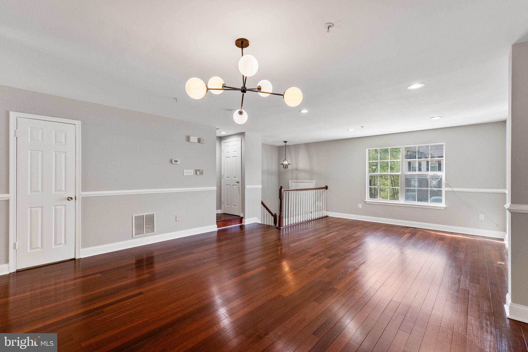 3514 Corn Stream Road Randallstown, MD 21133 - Photo 10 of 44 a view of an empty room with wooden floor and a window