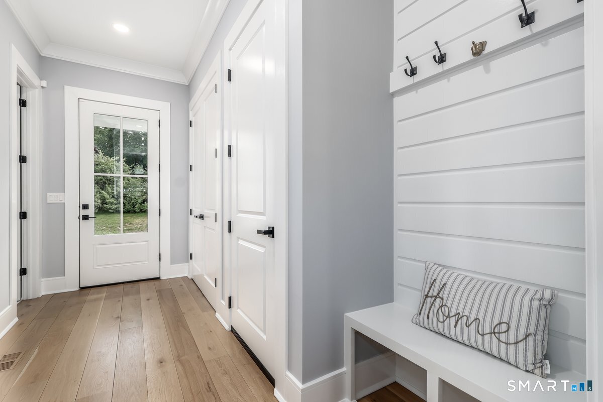 2 Pond View Lane Sherman, CT 06784 - Photo 17 of 40 a view of a hallway with wooden floor and cabinet