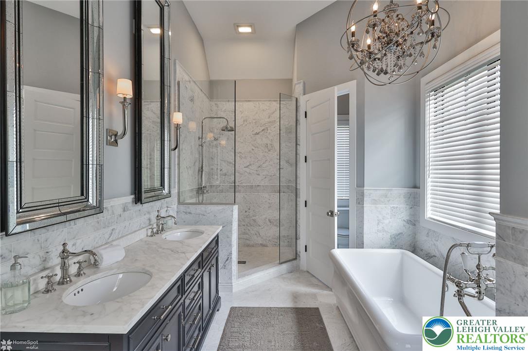 4850 West Hopewell Road Center Valley, PA 18034 - Photo 62 of 96 a bathroom with a granite countertop tub sink and mirror