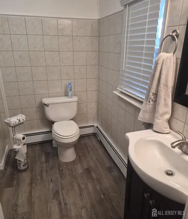 a white toilet sitting next to a bathroom sink