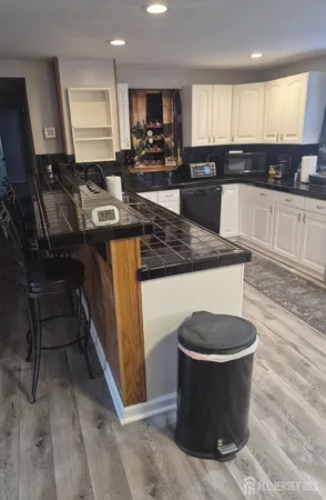 a kitchen with a sink cabinets and wooden floor