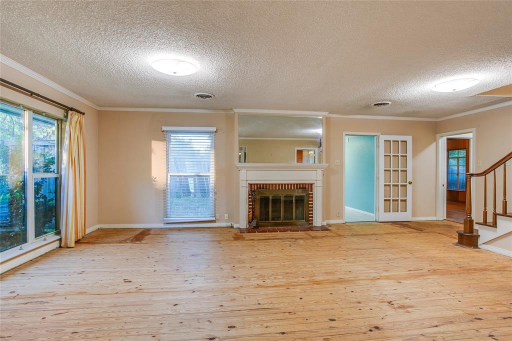 1439 Jr Drive Dallas, TX 75208 - Photo 3 of 39 a view of an empty room with window and fire place