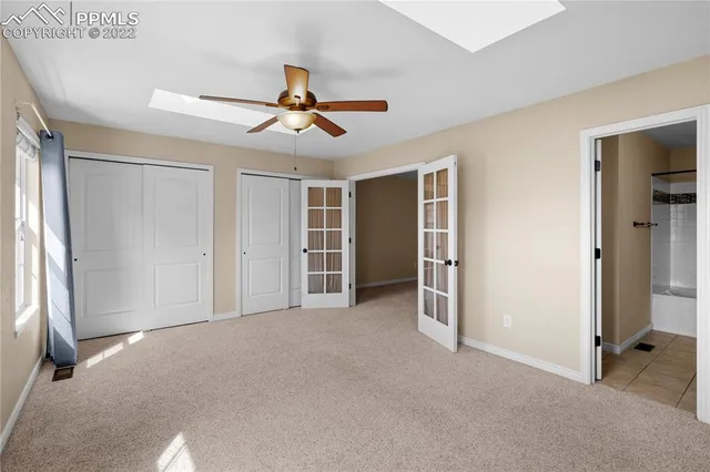 a view of a hallway with an empty room and a bathroom