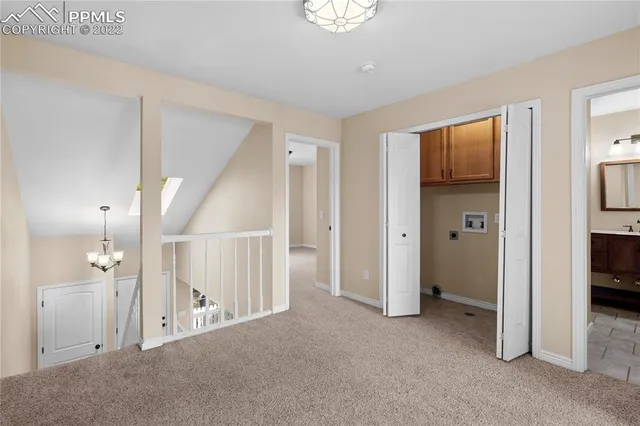 an empty room with closet and a window