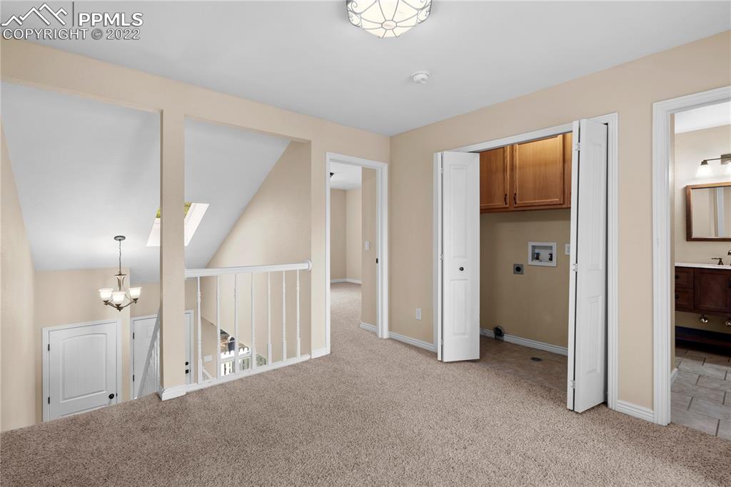 6910 Los Reyes Circle Colorado Springs, CO 80918 - Photo 15 of 38 a view of a hallway with an empty room and a bathroom