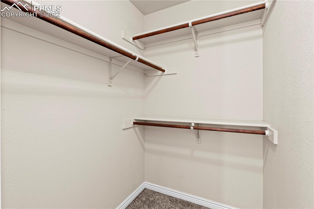 6910 Los Reyes Circle Colorado Springs, CO 80918 - Photo 17 of 38 a view of a room with racks on the wall