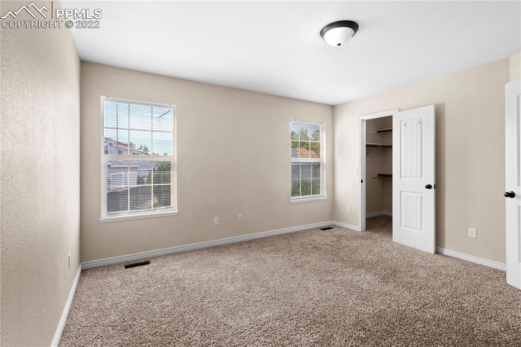 6910 Los Reyes Circle Colorado Springs, CO 80918 - Photo 19 of 38 an empty room with windows